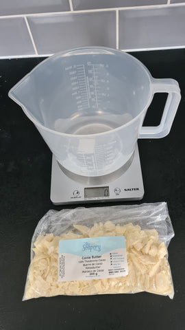 Weighing cocoa butter for soap making