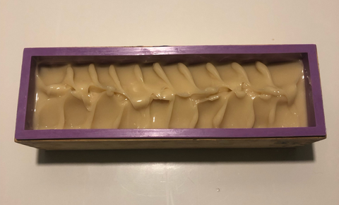 Pouring goat milk soap into moulds