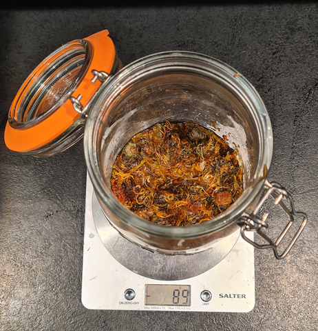 Filter the calendula infused oil for soap making