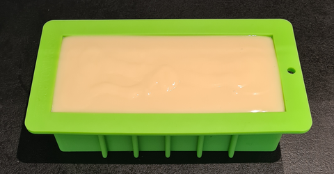 Pouring cocoa butter soap into moulds