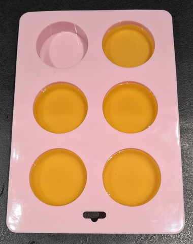 Pouring dog nose balm into moulds