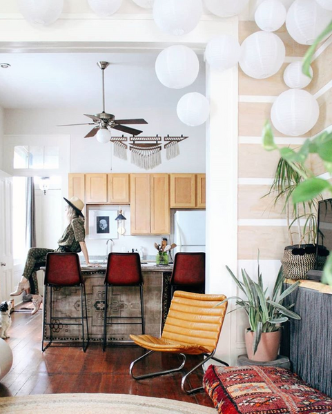 Liz Kamarul sits on counter top with rugs as counter face