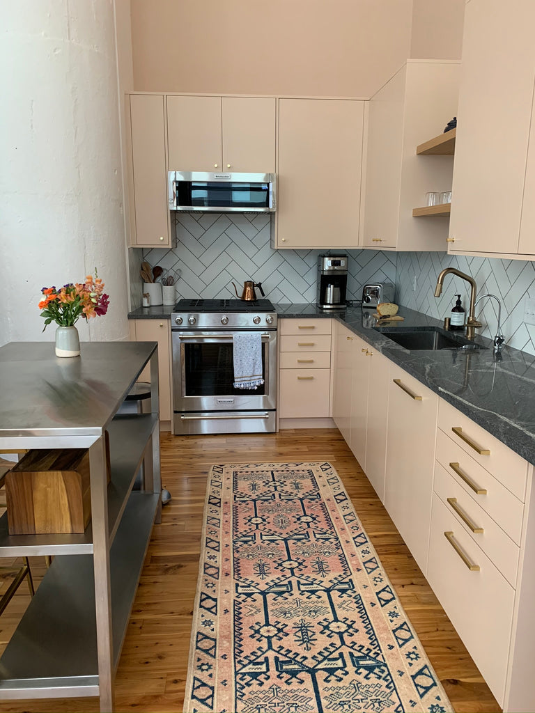 Pink kitchen featuring a vintage swoon rug
