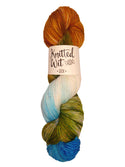 A photo of a hank of Hovenweep yarn with orange, blue, green and neutral tones