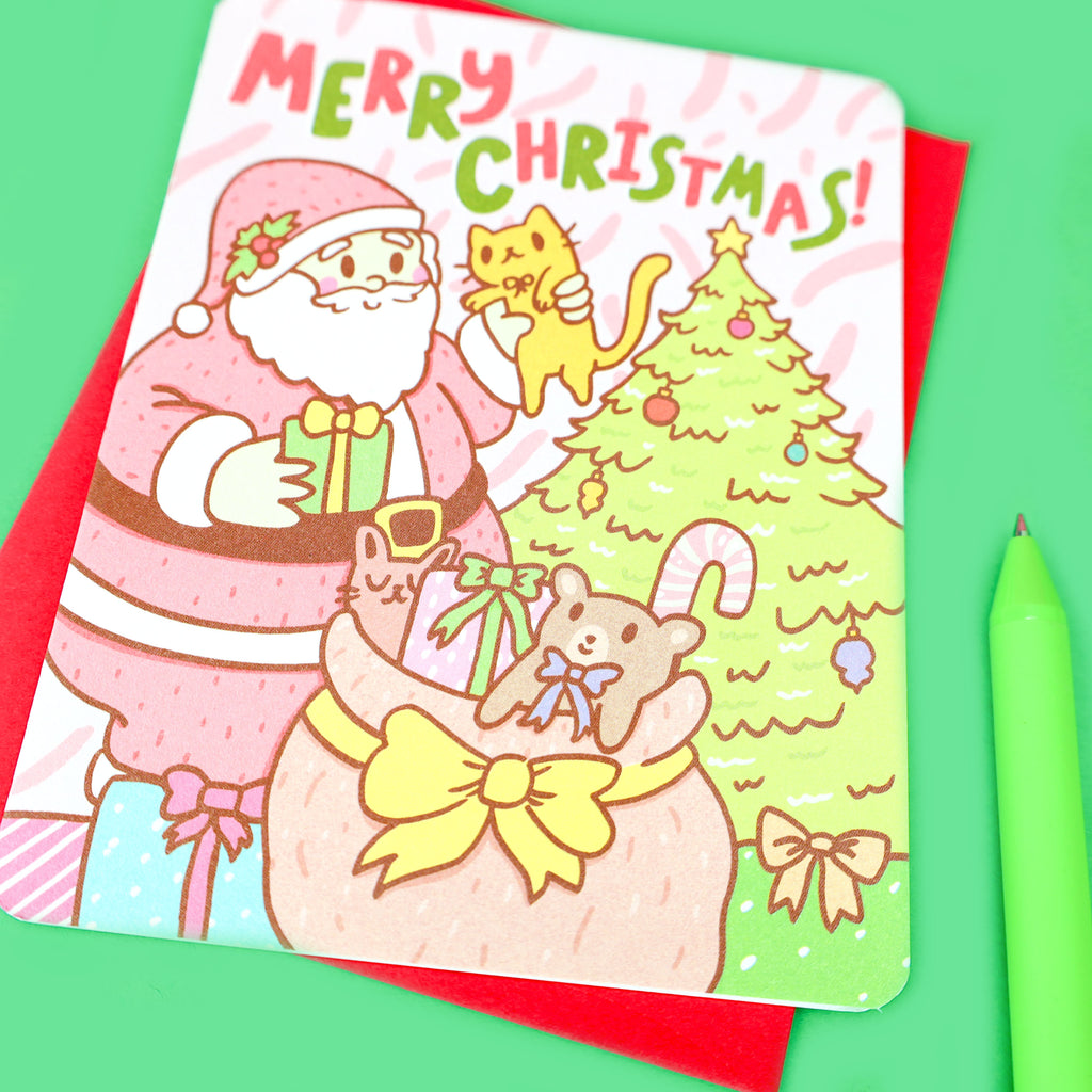 https://cdn.shopify.com/s/files/1/1271/9431/products/Merry-Christmas-Jolly-Santa-Presents-Holiday-Card-By-Turtles-Soup-Happy-Holidays-Santa-Claus-Saint-Nicholas-Kris-Kringle-Santa-Card-Cute-Gift-Red-Green_1024x1024.jpg?v=1621221706