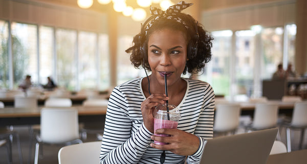 Mix of berries make the smoothie this woman is drinking super healthy and great for avoiding colds.