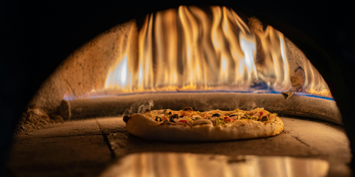 Cooking Pizza in an Outdoor Wood-Fired Oven