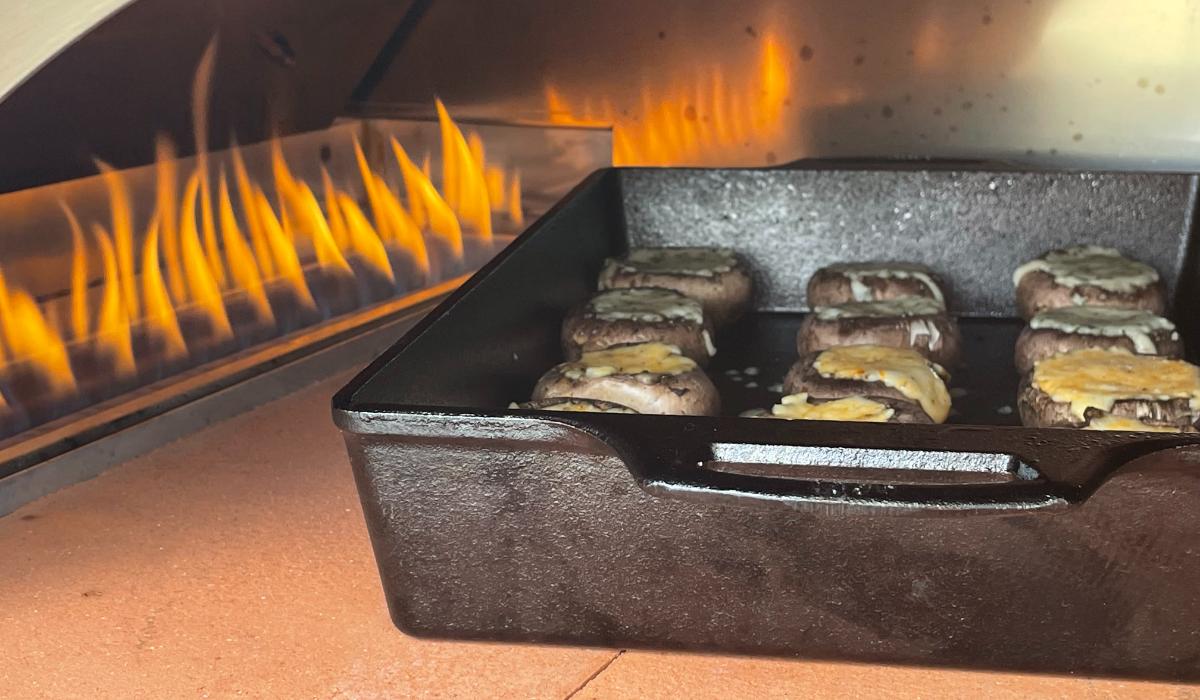 Mushrooms cooking in a gas-fired pizza oven