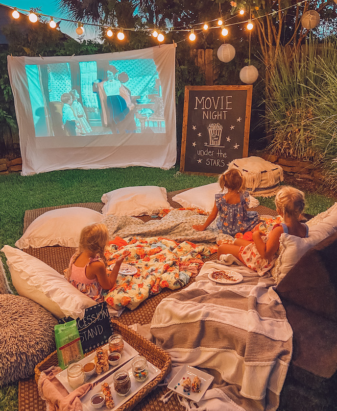 Family outdoors watching movie 