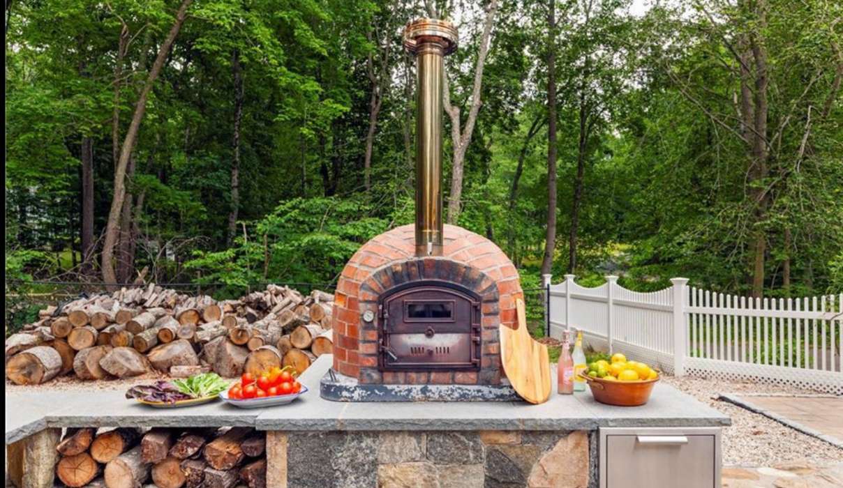 Brick pizza oven on a backyard patio