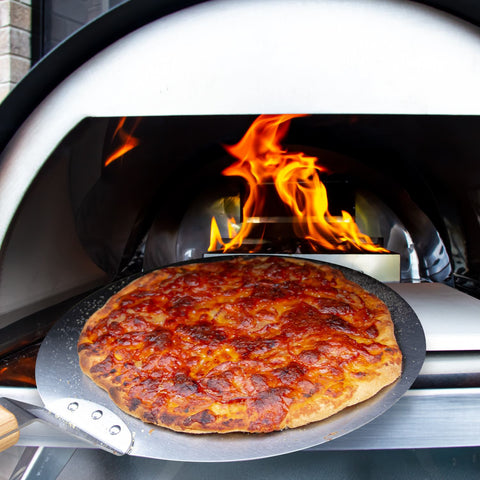 Cooking pizza in a small gas pizza oven