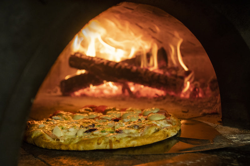 Wood burning in a large pizza oven