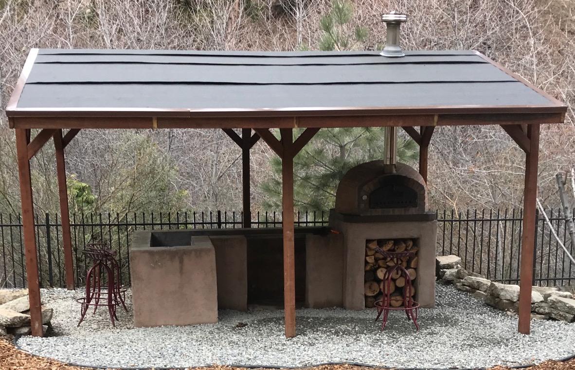 Brick pizza oven under gazebo