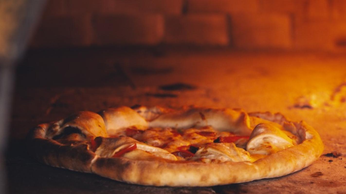 Authentic pizza cooking in a brick oven