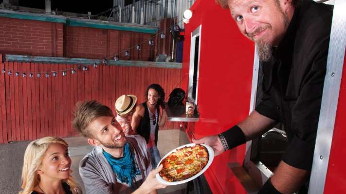 Man selling pizza from food truck