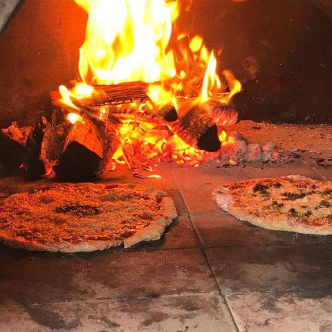 Pizzas cooking in pizza oven