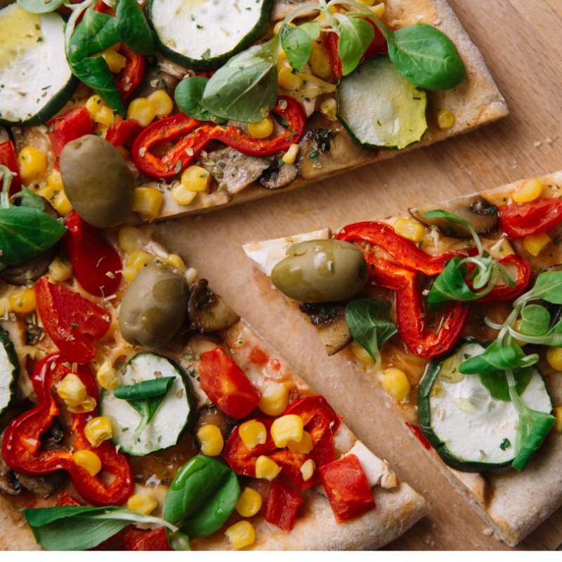 Vegan Pizza with olives, peppers, corn, mushrooms and cucumbers