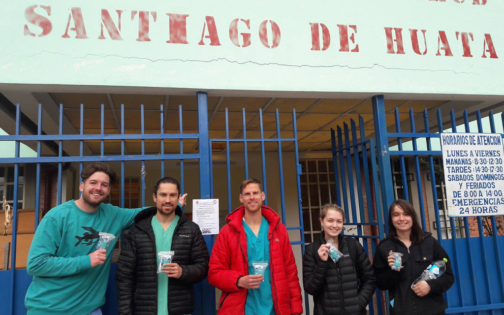 Caption: Doctor Angerbauer (second from left) and his team get ready to share Lena Cups with members of the community.