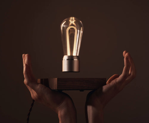 Flyte levitating Marconi bulb, hands holding the base in the air