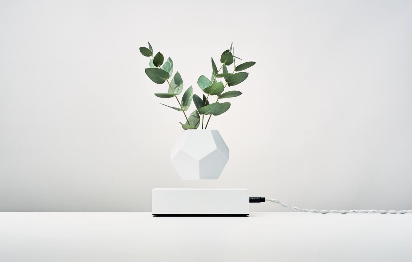 Levitating planter Lyfe by Flyte, white cover base version with with white planter on a light background