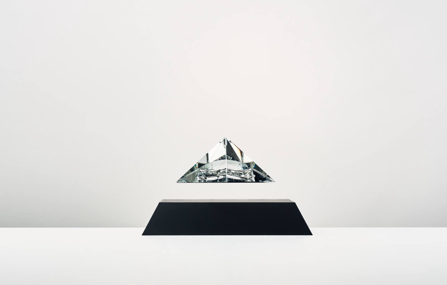 Py levitating crystal pyramid, black cover base, clear crystal top