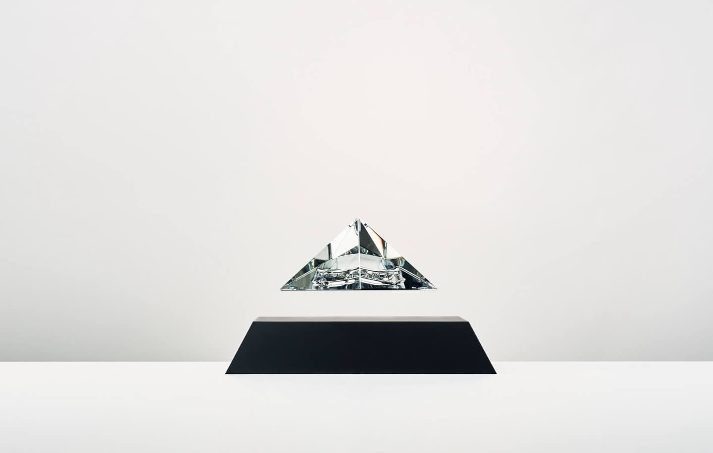 Py levitating crystal pyramid, black cover base, clear crystal top