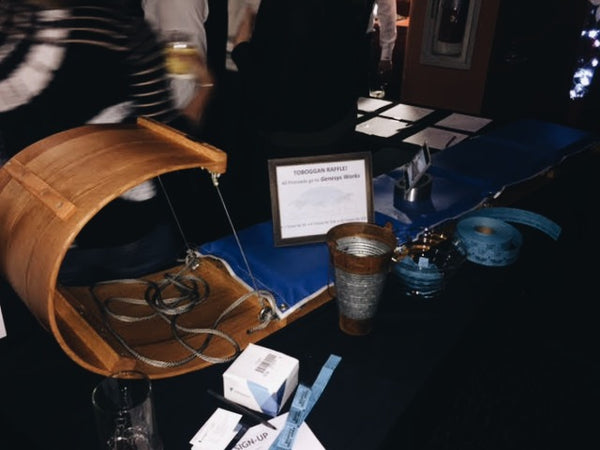 Wood toboggan sitting on a table at a craft fair