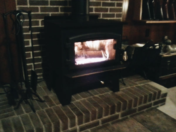 Traditional Wood Stove, burning logs in a cabin