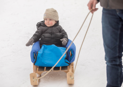 Child being pulled in Child's Pull Sled