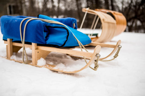 children pull sled winter toboggoan