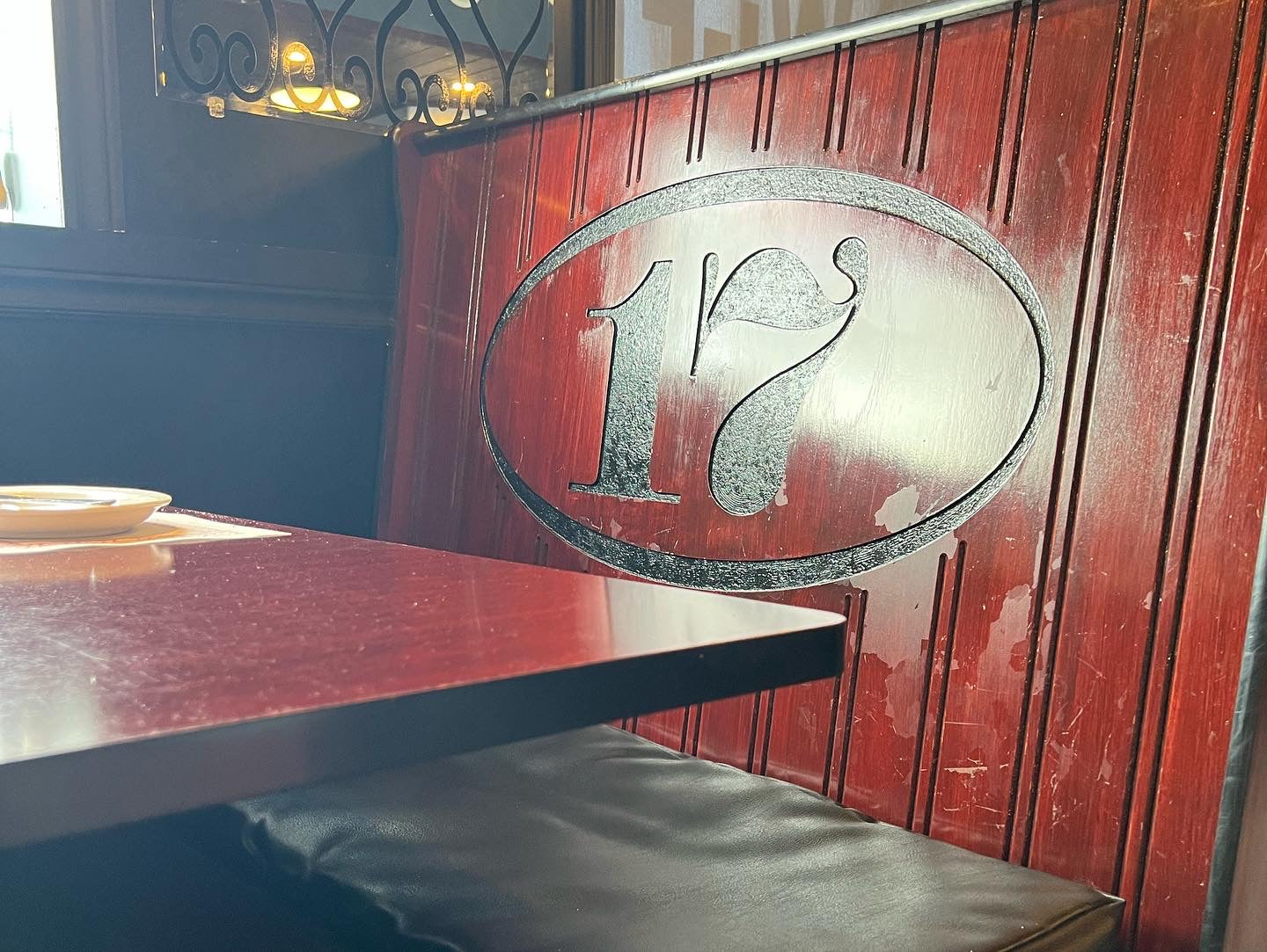 Image of a booth at 17 Restaurant in Blind River, Ontario, CA with the logo on the back of the booth