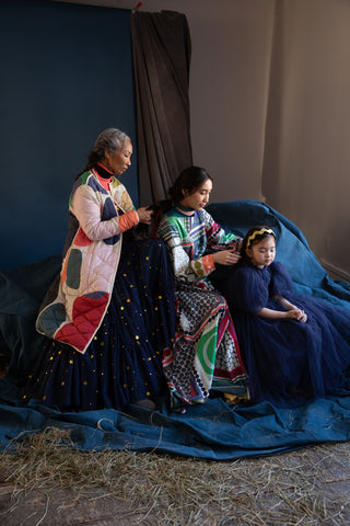 Jackie, Glorietta, and Ella braiding each other's hair in the generation photo to show women and girls styles