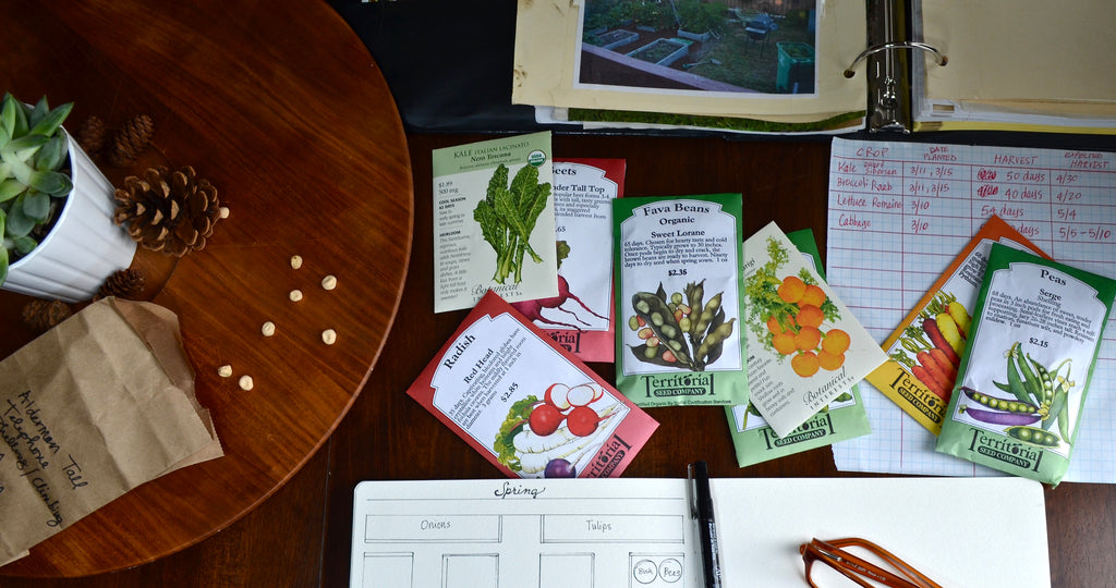 table top garden planning with garden binder and seed packets