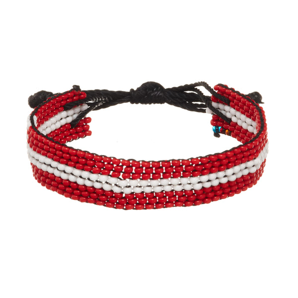A beaded ArtiKen bracelet, handmade in Kenya, in Denmark flag colors, red, white. 