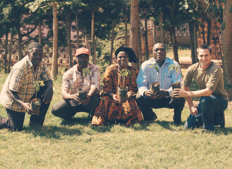 Jeff and Moka Origins Farmers hold sapling coffee plants.