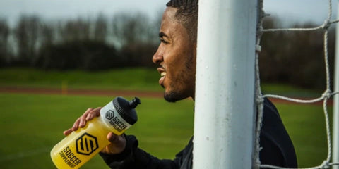 Footballer with hydration drink