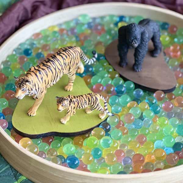 Water beads in sensory tray with Wild CollectA animals and play boards