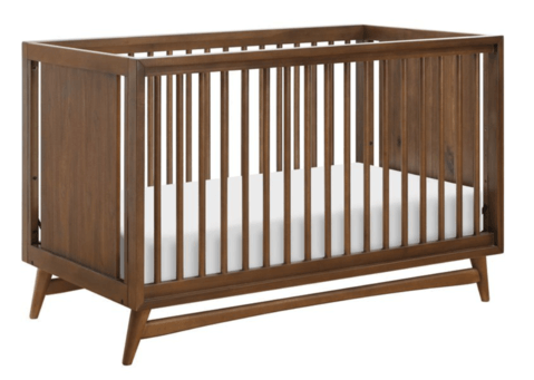 How to decorate a nursery - choosing a mid-century modern crib. A dark brown crib with clean lines.