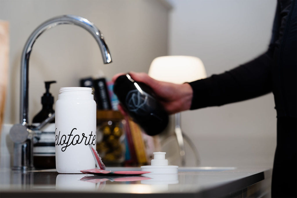 Filling up water bottle for hydration before boxing