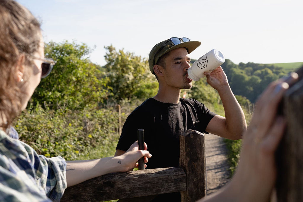 Man hiking with water bottle for hydration