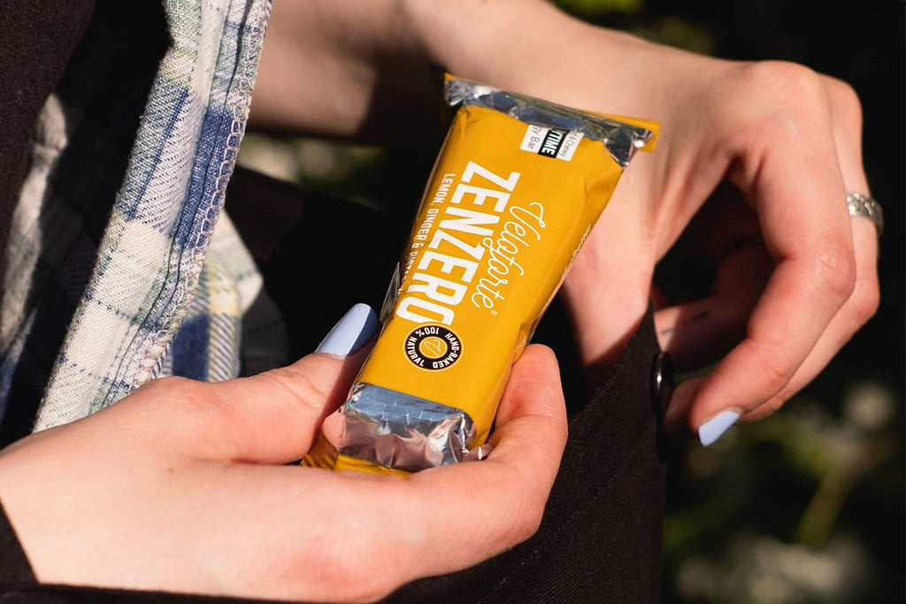 Woman holding an energy bar for swimming nutrition