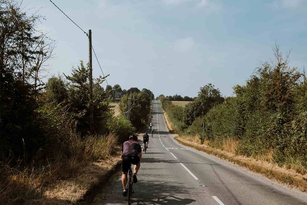 cyclists showing endurance while doing a long cycling on a road