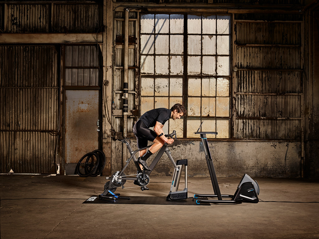 A cyclist is working out in a turbo trainer.