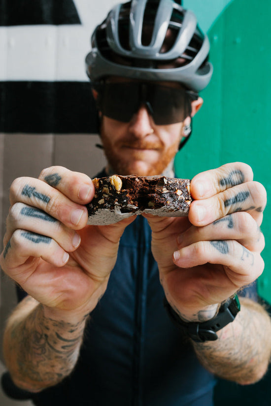 A man holding a Veloforte energy bar