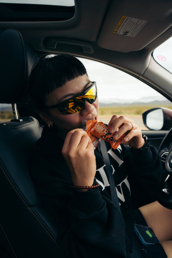 A woman eating a Veloforte Classico Energy Bar