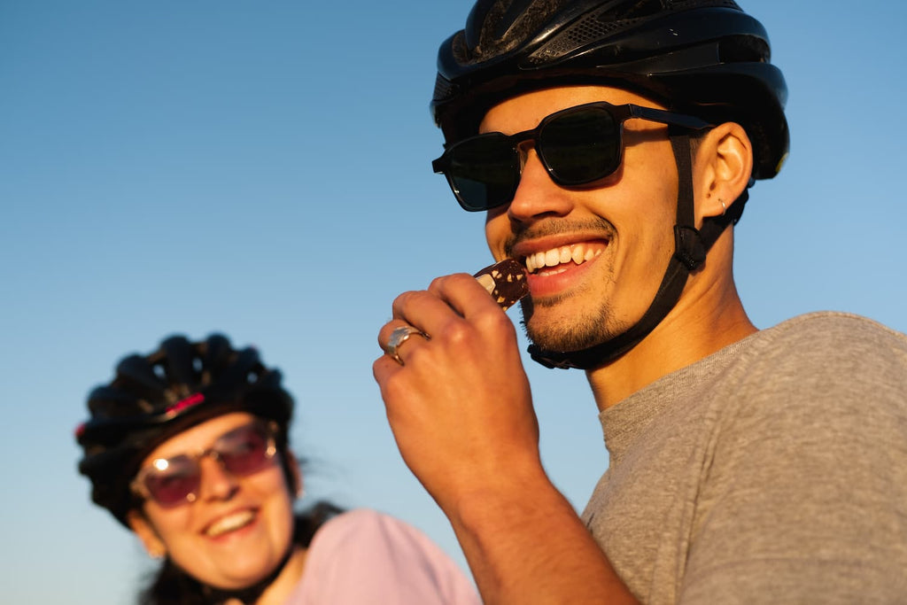 Eating energy bar with cycling helmet