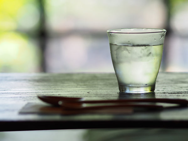 A cold glass of water on table.