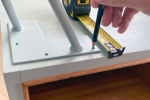 marking hairpin leg mounting holes with a pencil