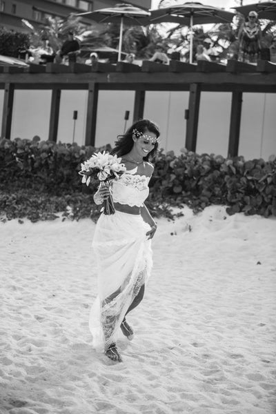 Beach bride in barefoot sandals and boho crop top wedding dress