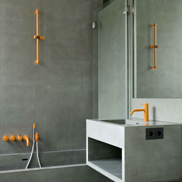 Concrete Bathroom with Orange Vola Taps